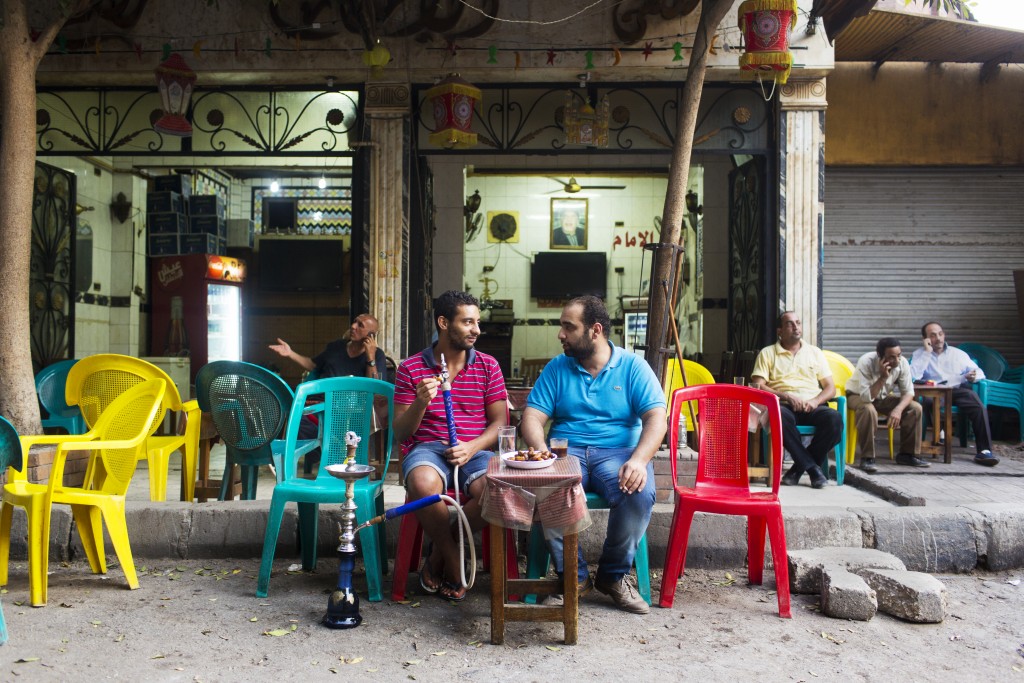 Ahmed Adel Abdel Hameed and Nadeen Mohamed Badawi eat dates, drink coffee and smoke shisha at the terrace of a cafe in Dokki, Cairo, Egypt.