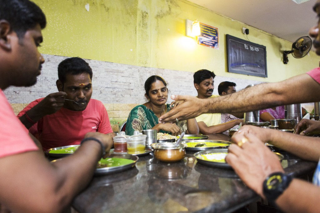 Customers enjoy a meal in a restaurant specialising in rice dishes in Bellathi, Coimbatore, India.