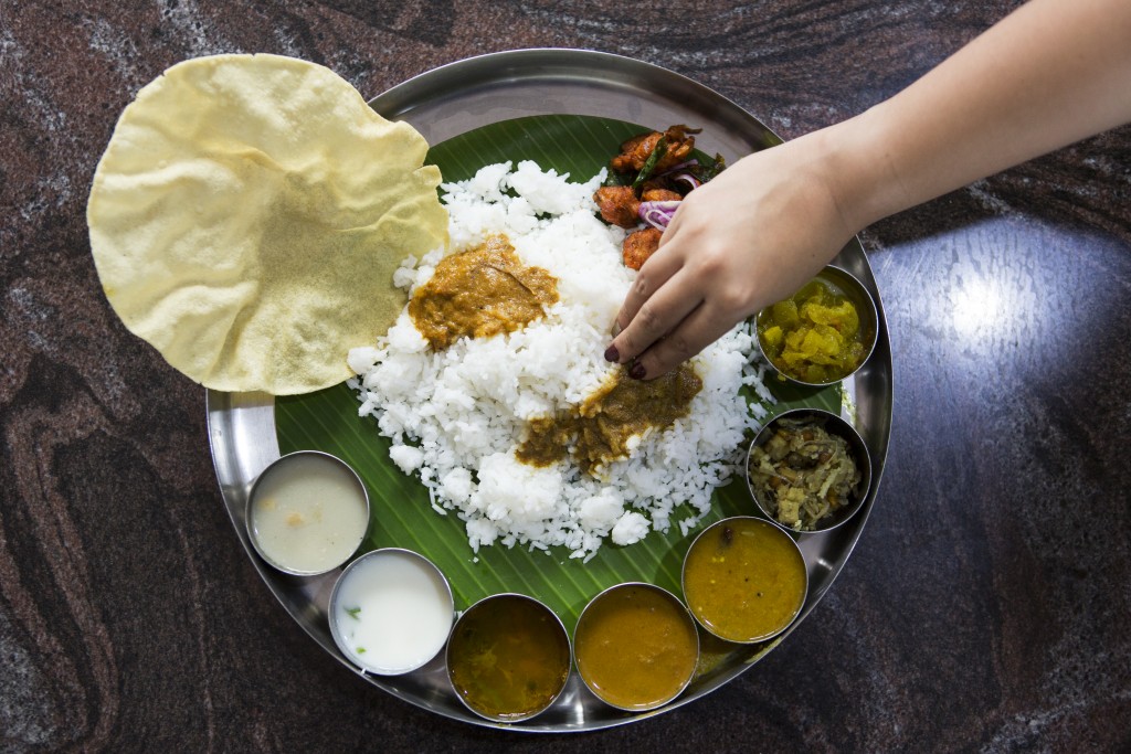 A rice dish with a variety of sauces and curries, Bellathi, Coimbatore, India.