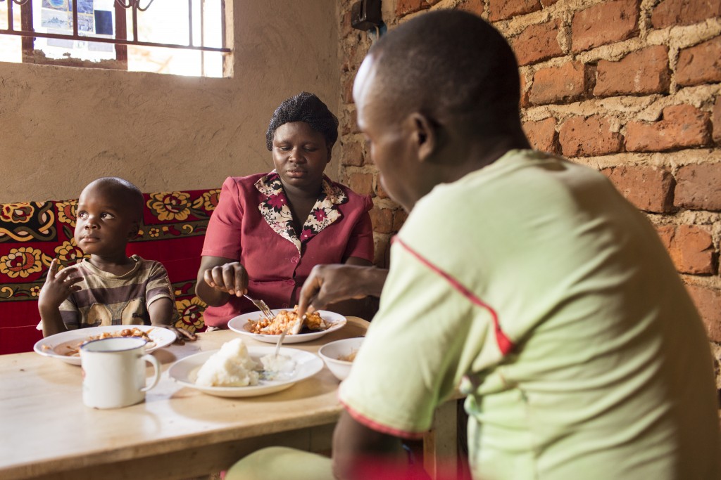 Agnes Makilumda, with husband Makesa Lozio and son Nyombi Temdo, eating Ugali, Namulonge